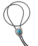 One-of-a-kind Damascus bolo tie with texture inspired by sandstone cliffs as a background to Kingman turquoise cut into a sterling silver bezel.  Extra long bolo cord can be worn in the classic style or doubled up as a choker style bolo.  Sterling silver sandstone texture bolo ends.
